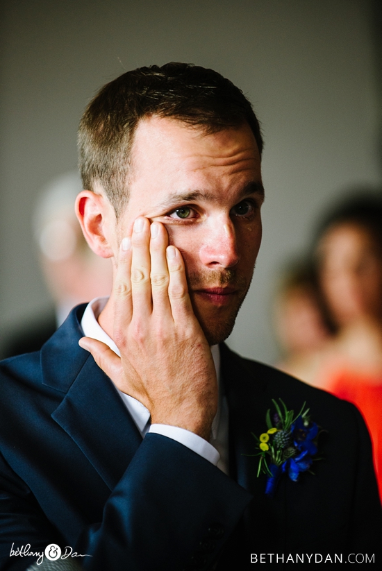 The groom wiping away a tear