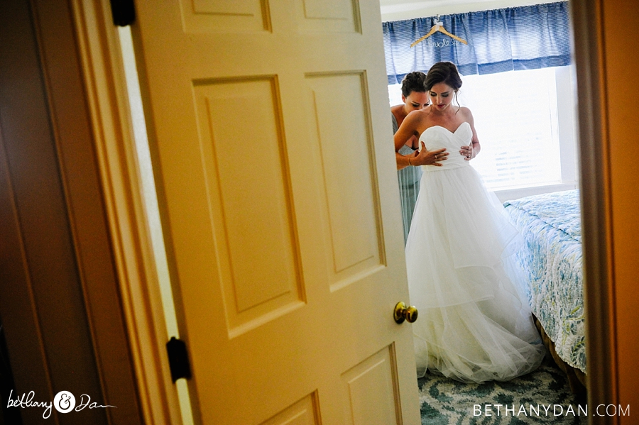 The bride getting in her dress in Southport Maine