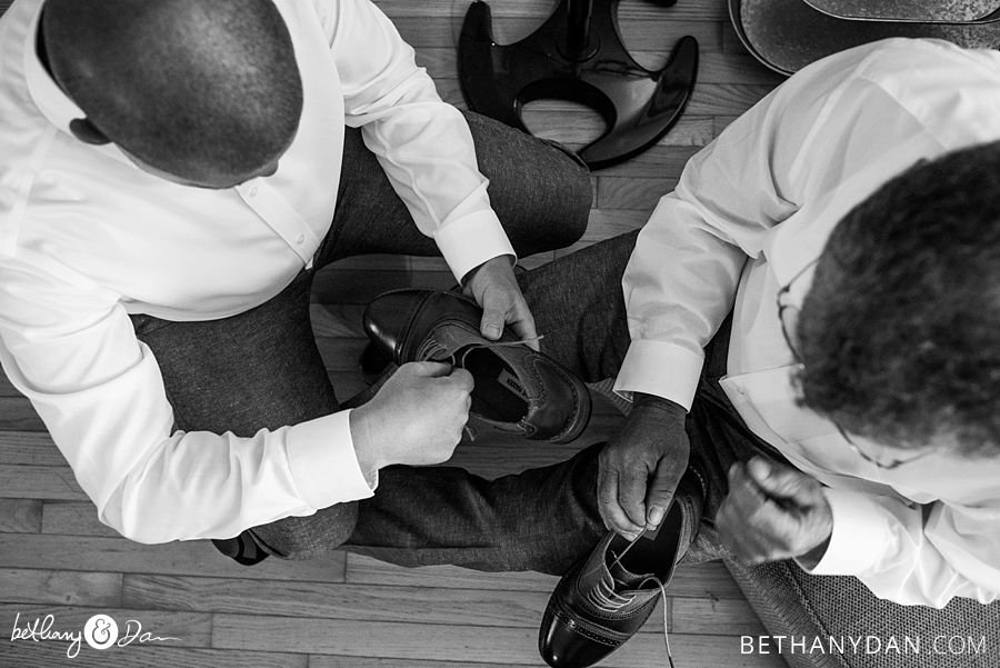The groom puts on his shoes