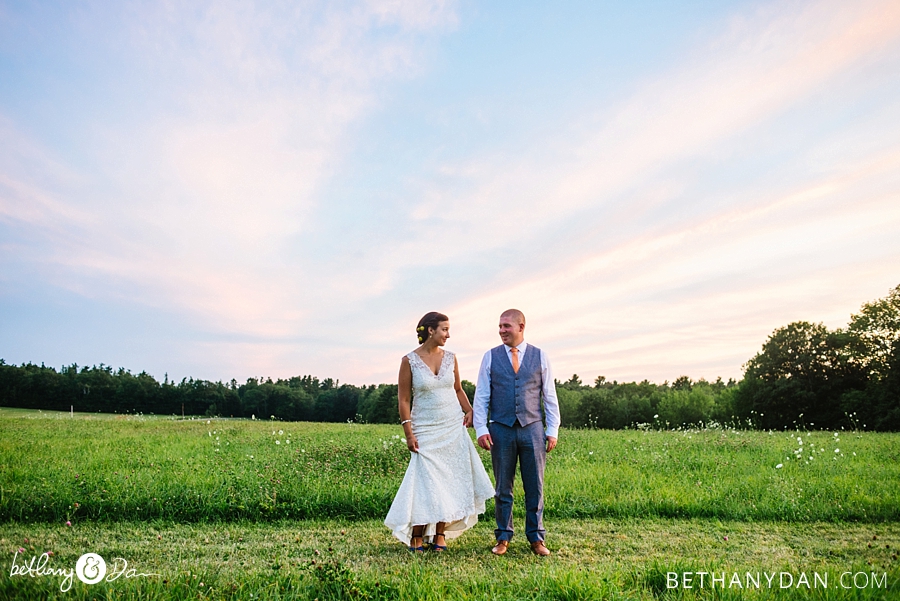 The bride and groom in a field