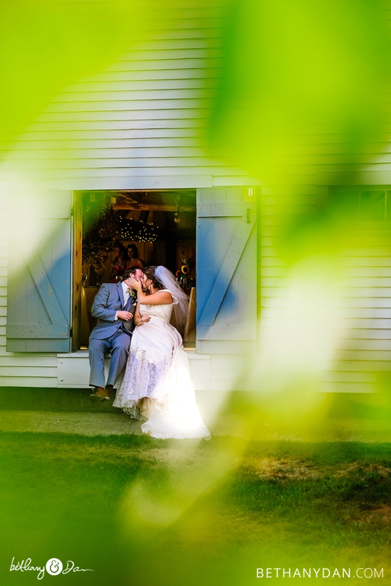 The bride and groom in the barn doors